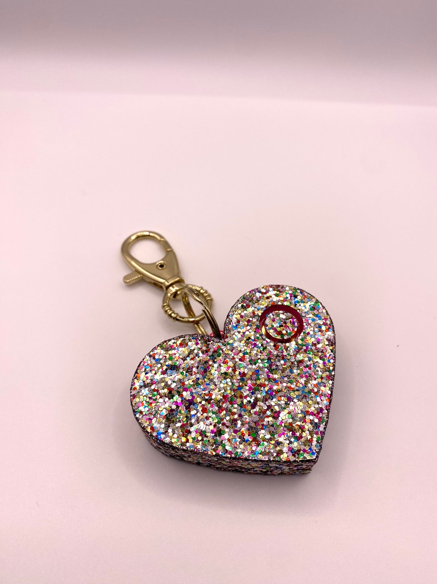 multi colored glitter heart shaped personal alarm with gold lobster clamp