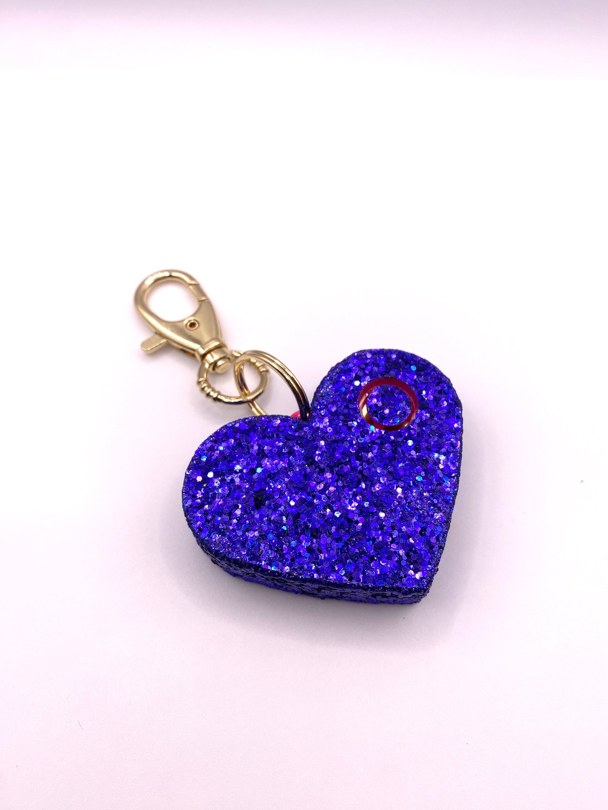 blue glitter heart shaped personal alarm with gold lobster clamp