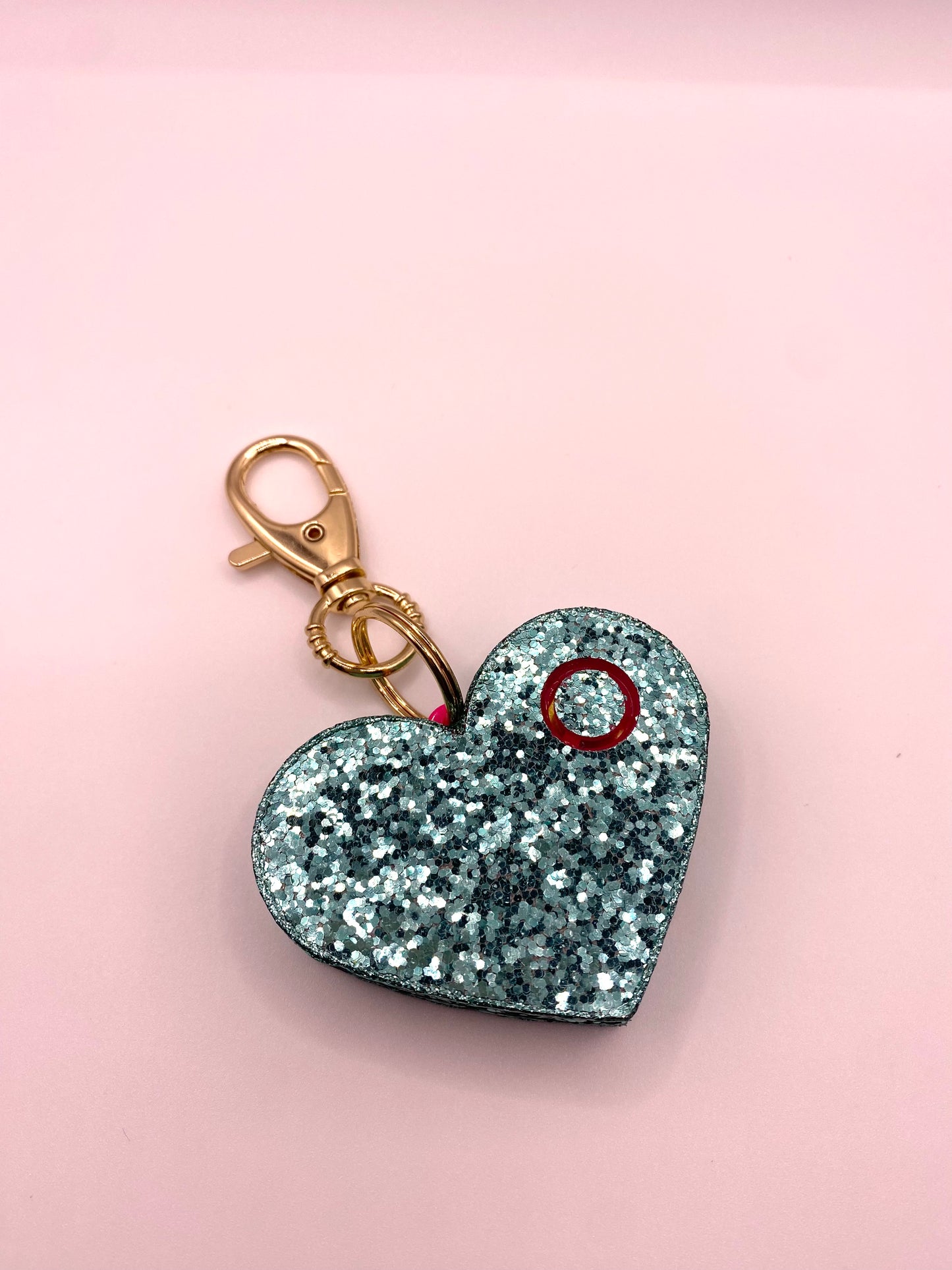 teal glitter heart shaped personal alarm with gold lobster clamp