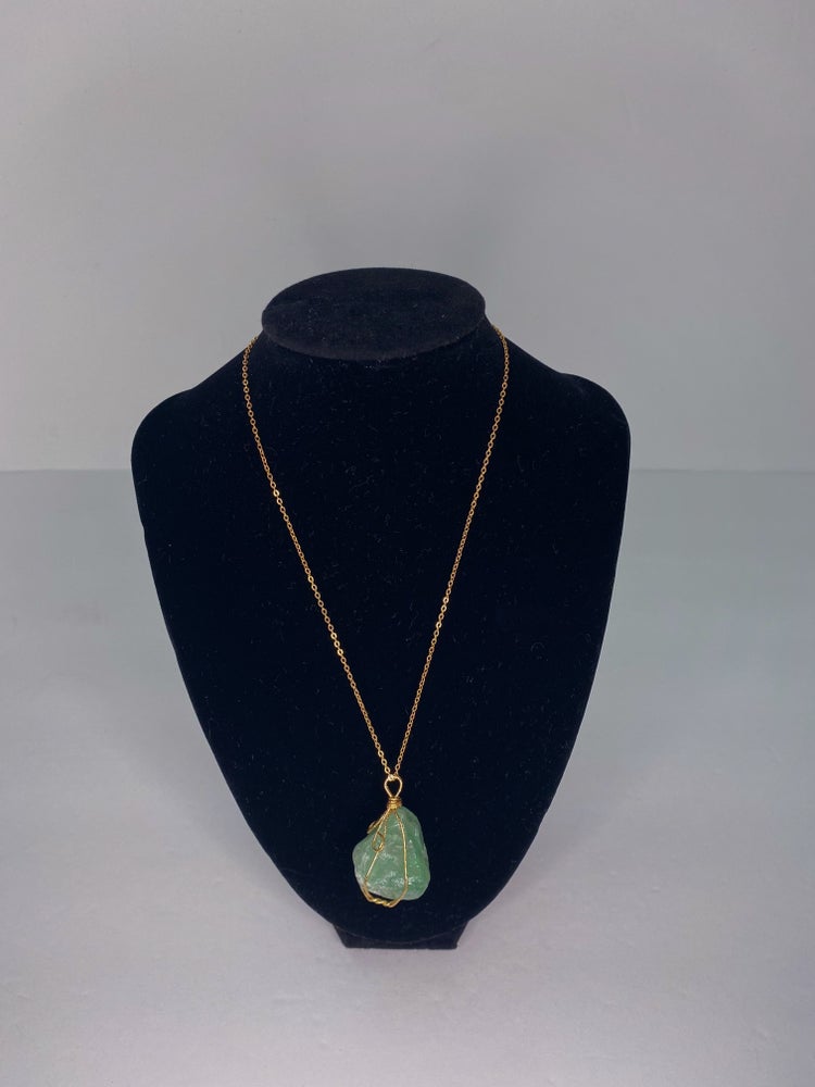 green crystal rock necklace with gold detail and gold chain