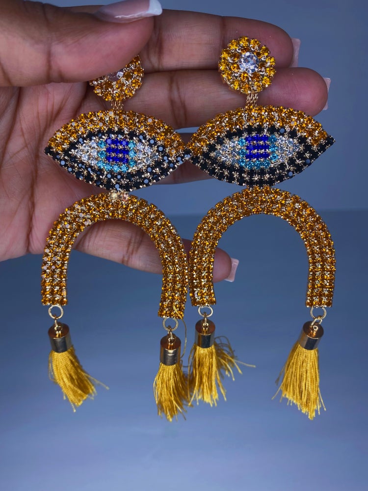 Evil eye silver, blue, gold and black rhinestone dangle earrings with gold tassel detail